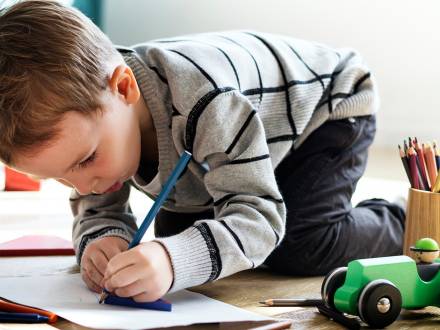 Young boy coloring with pencils