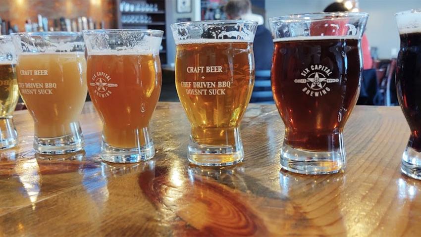 A flight of colorful beers from Six Capital Brewing & BBQ located in Aurora Colorado