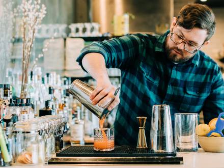 Bartender at Annette pours creative cocktail in Aurora Colorado