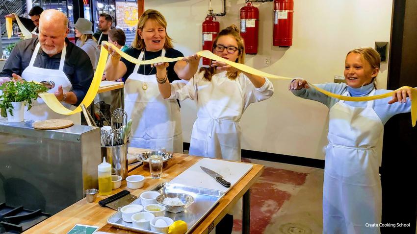 A family enjoying cooking at Create Cooking School in Aurora, CO