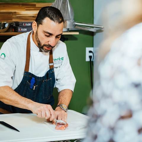 Chef and Co-Owner at Create Cooking School, Diego, prep food for a class in Aurora Colorado