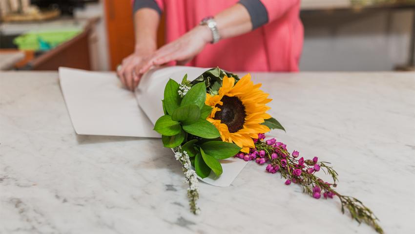 A colorful bouquet of flowers being prepared at Poppy & Pine in Aurora, Colorado