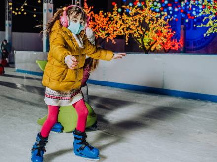 Young girl ice skates under the lights at Gaylord Rockies in Aurora Colorado