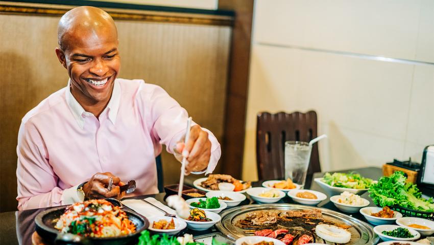 A trendy man enjoys Korean BBQ in Aurora Colorado