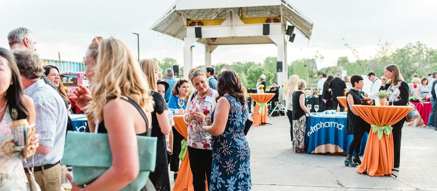 A crowd of meeting goers gathers at Stanley Marketplace in Aurora Colorado