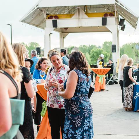 A crowd of meeting goers gathers at Stanley Marketplace in Aurora Colorado