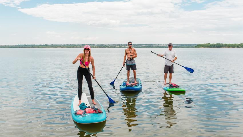 Some friends ride paddleboards in Aurora Colorado