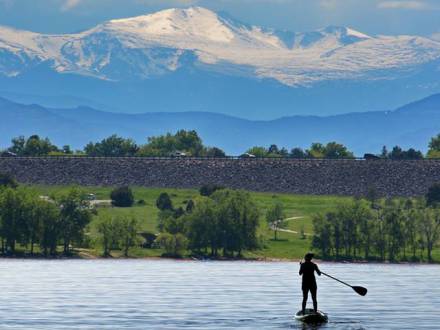 Women paddle boards at Cherry Creek State Park in Aurora Colorado