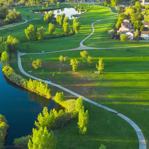 Green grass and walking paths create a colorful scene for Aurora's parks.