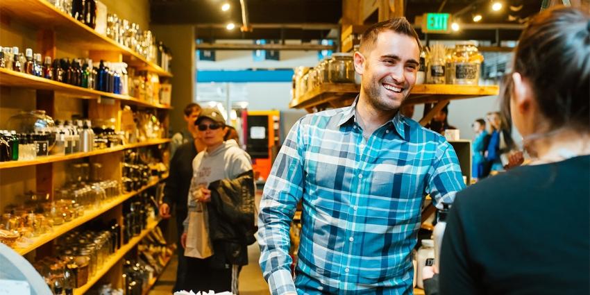 A man purchases sustainable items at ZERO Market inside Stanley Marketplace
