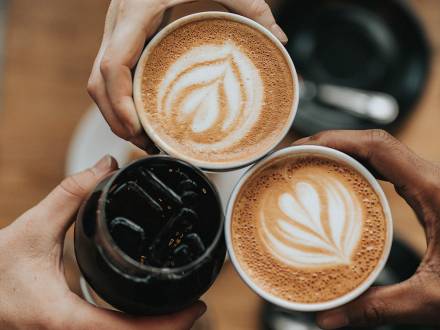 A group of friends cheers coffee