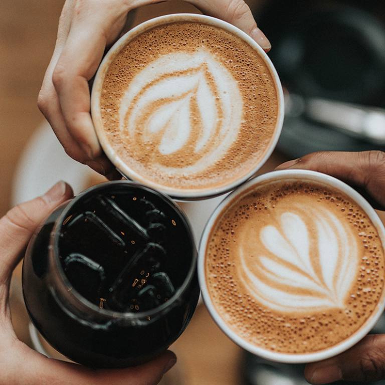 A group of friends cheers coffee